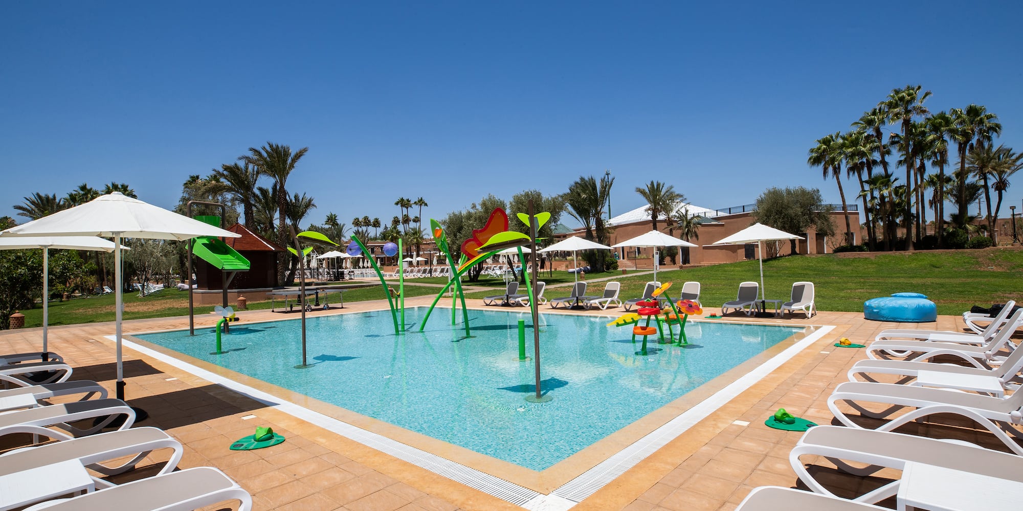 a pool with chairs and umbrellas