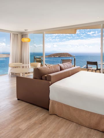 a room with a large window overlooking the ocean