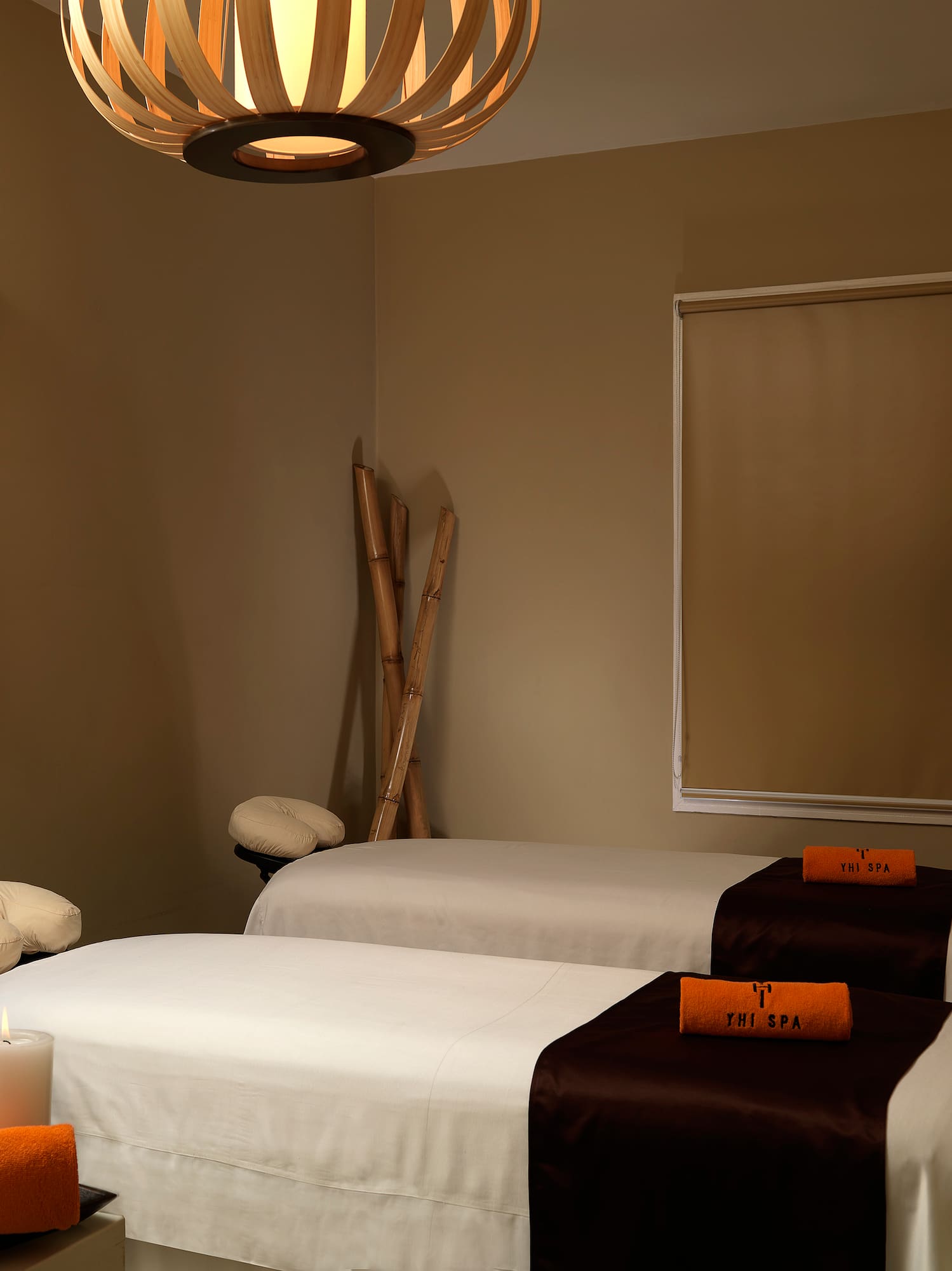 a room with two beds and candles