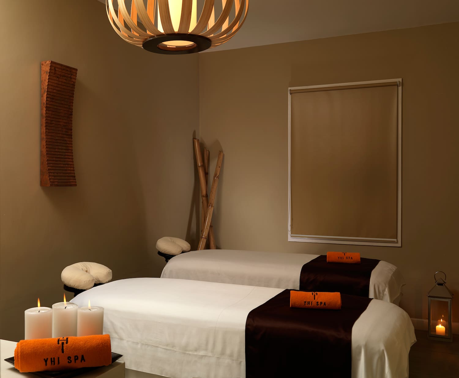 a room with two beds and candles