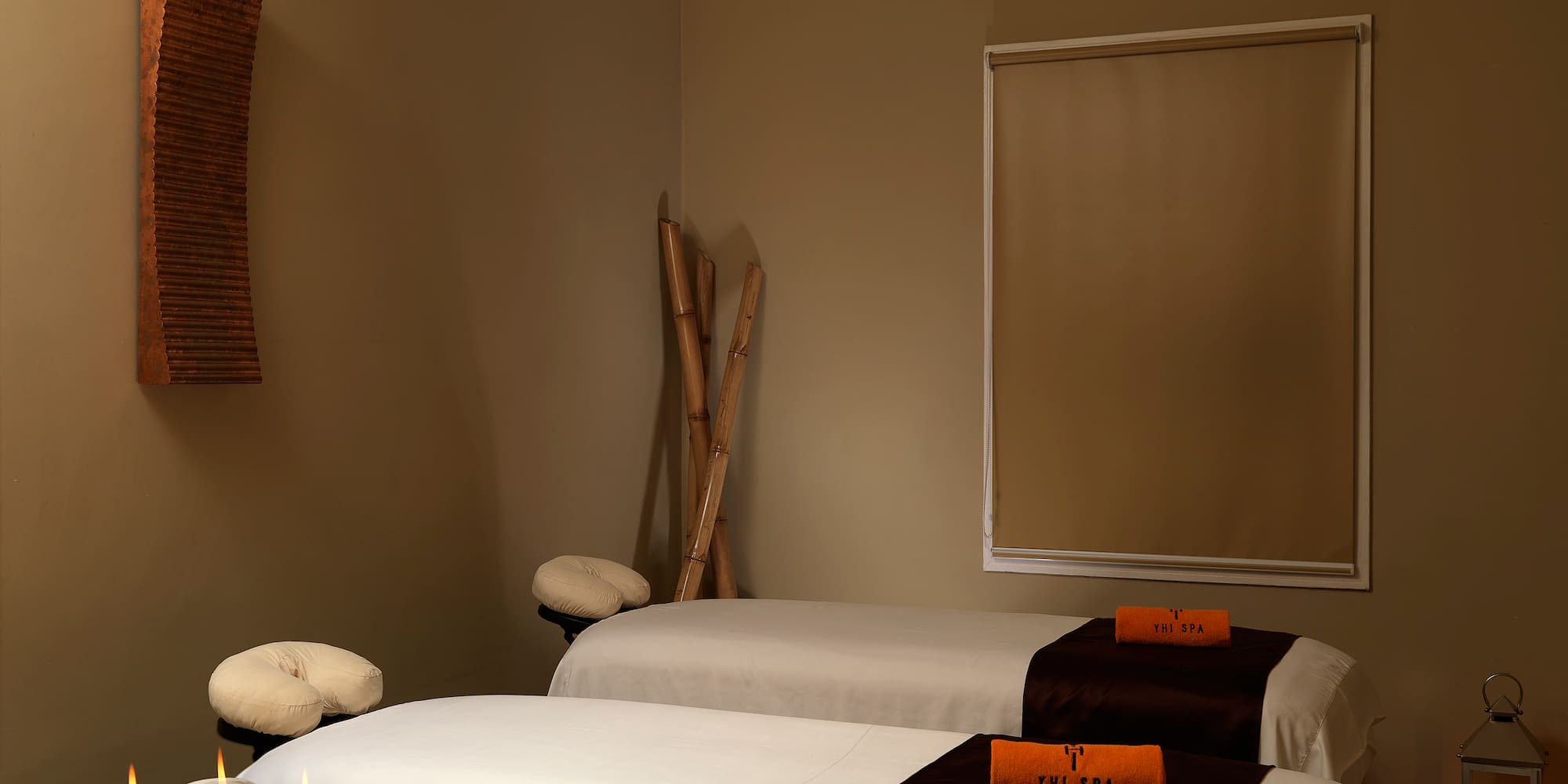 a room with two beds and candles