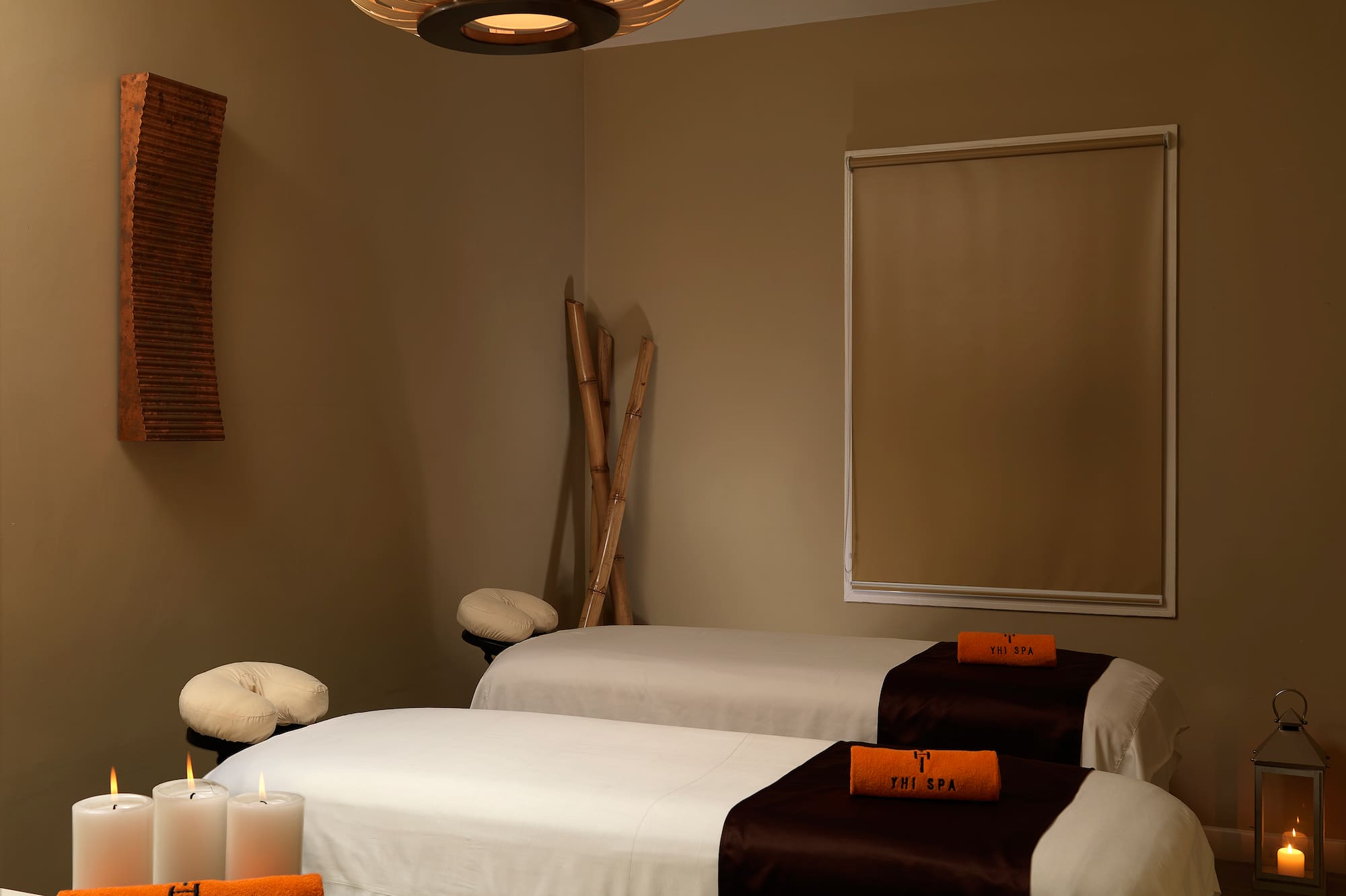 a room with two beds and candles