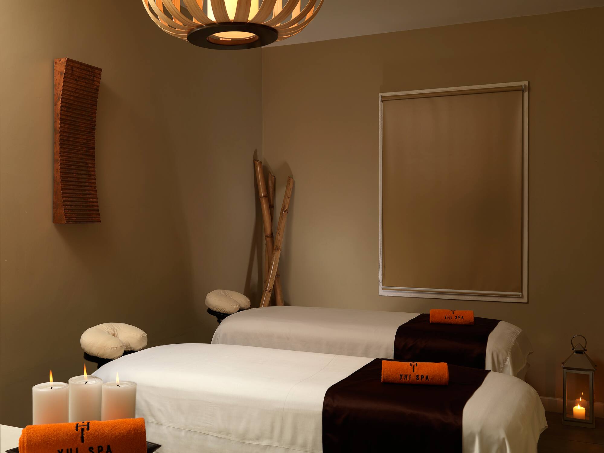 a room with two beds and candles