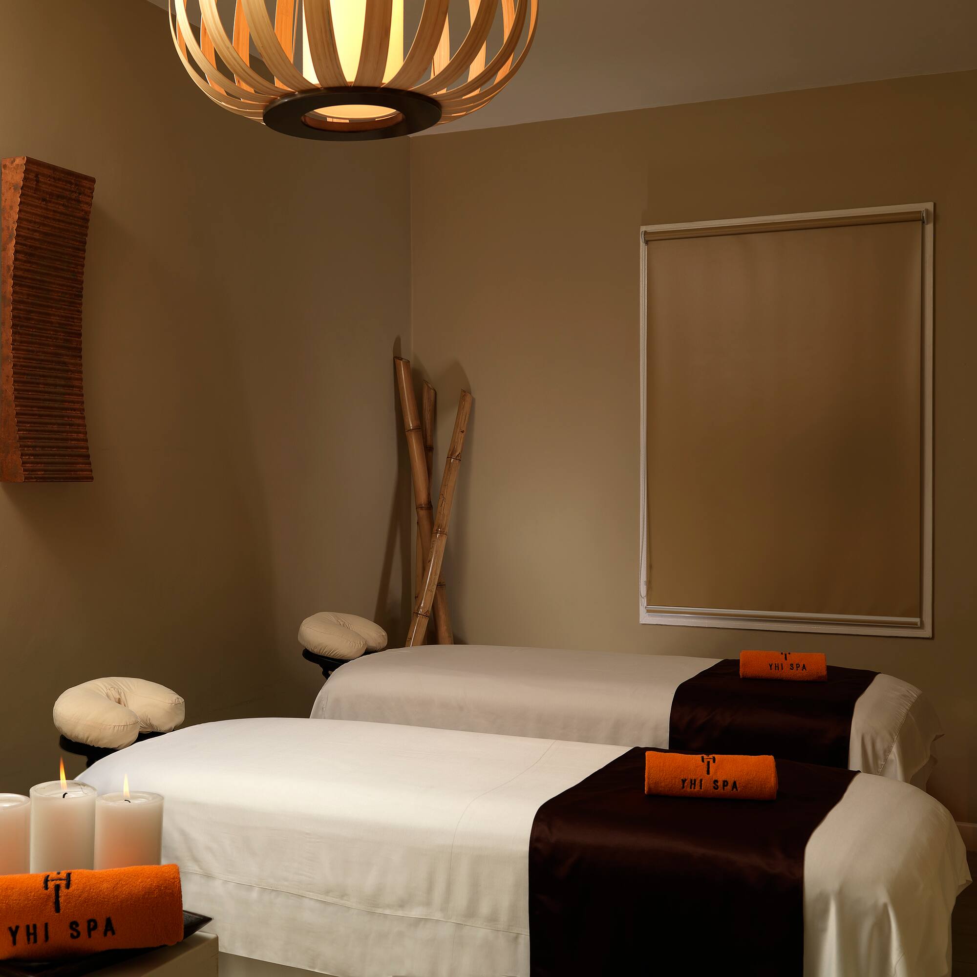 a room with two beds and candles