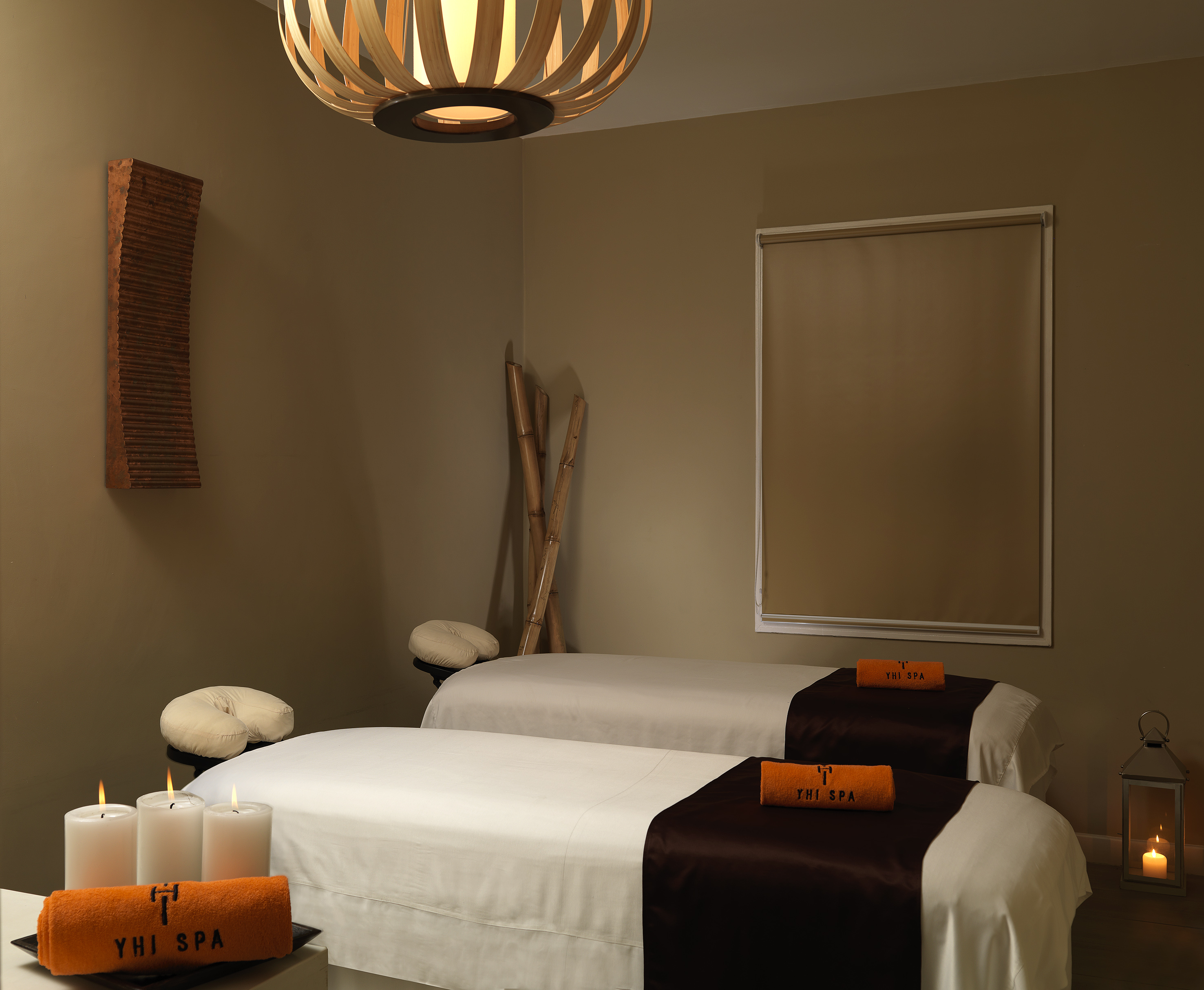 a room with two beds and candles