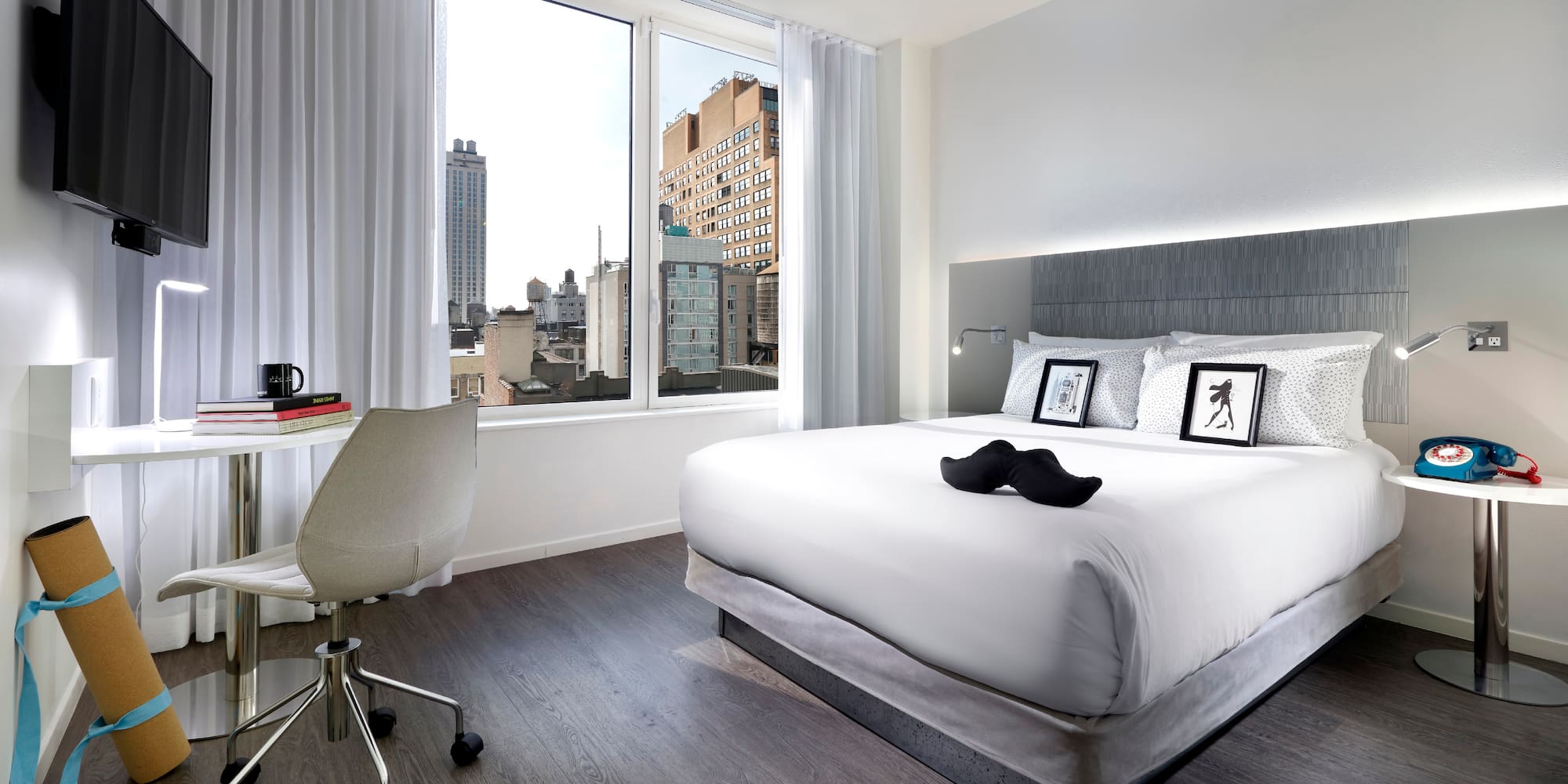 a bedroom with a bed and a desk and a chair