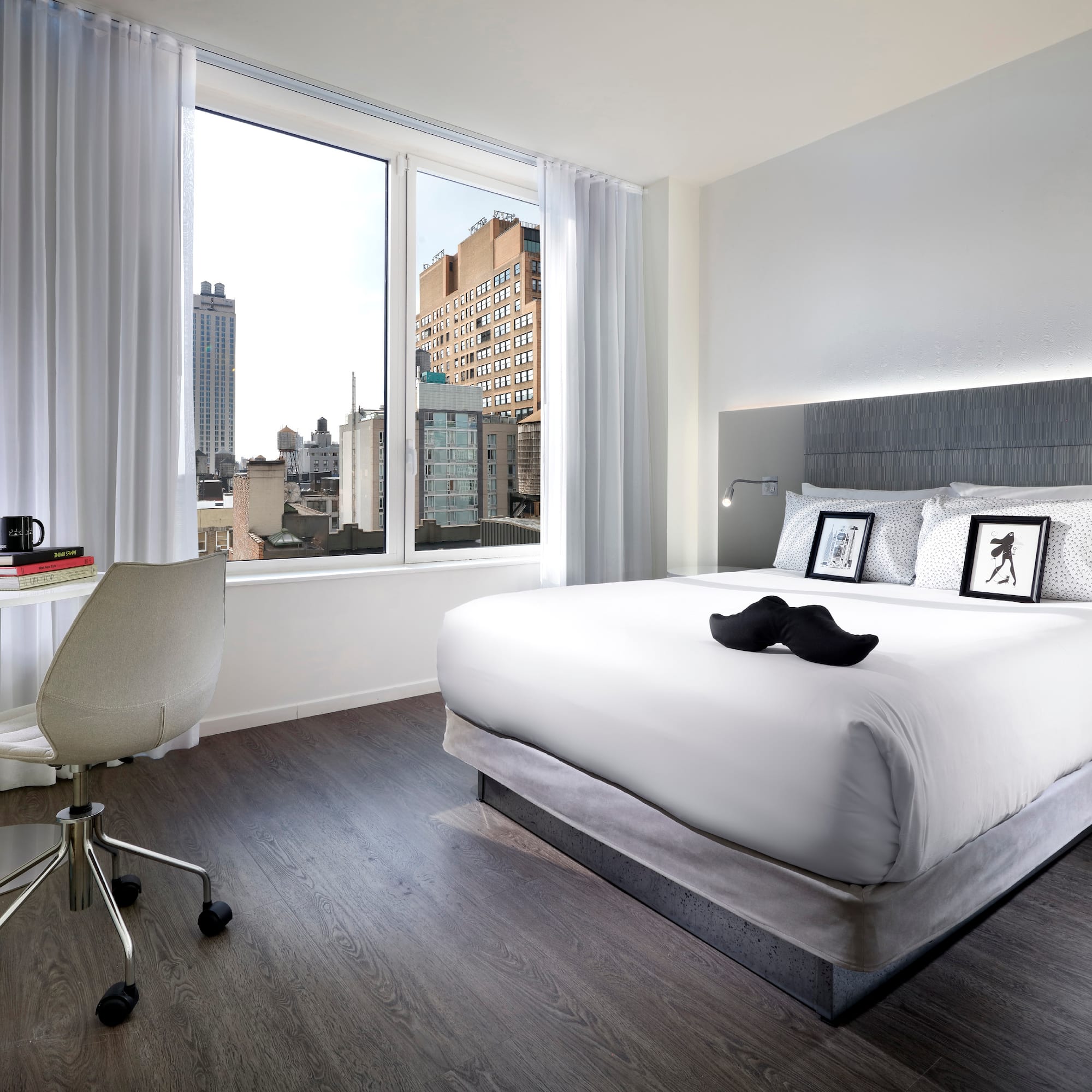 a bedroom with a bed and a desk and a chair