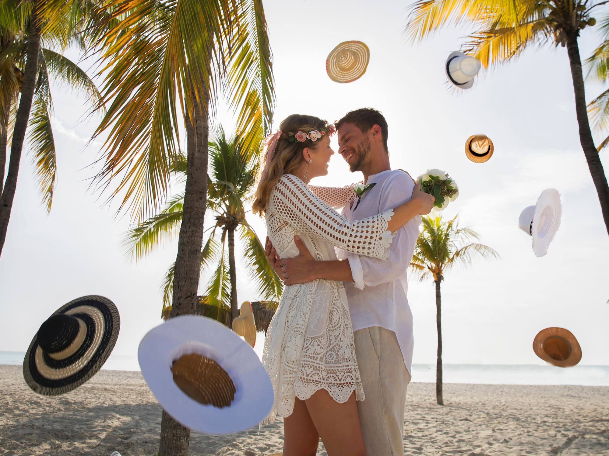 a man and woman hugging on a beach