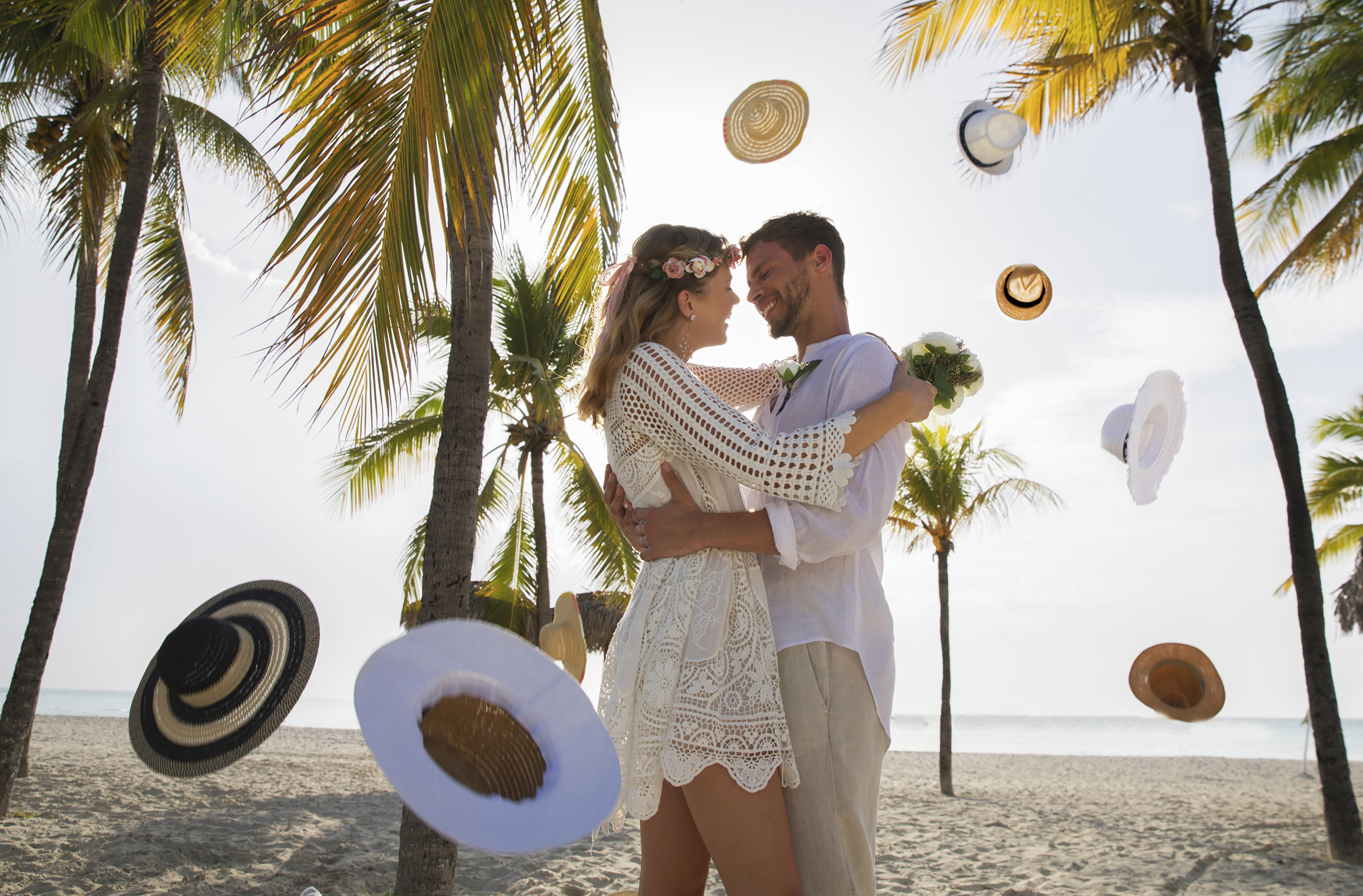 a man and woman hugging on a beach