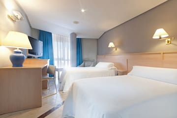 a room with two beds and a desk