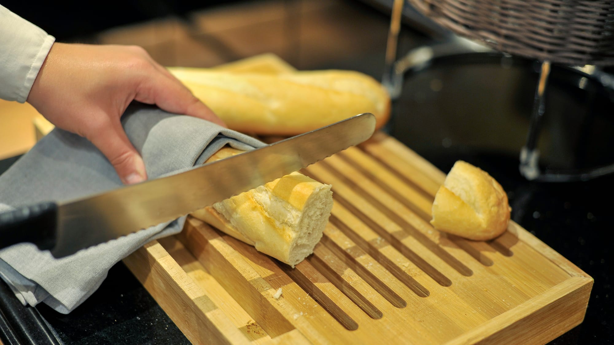a person cutting bread on a cutting board