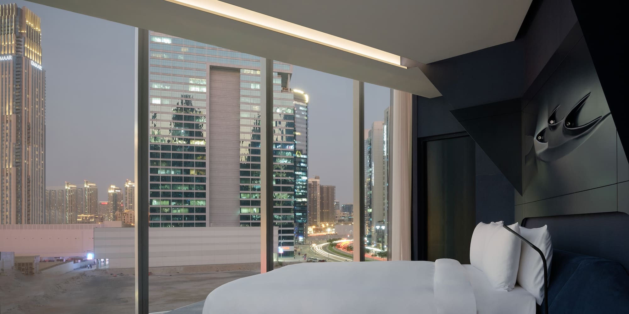 a bed with a view of a city