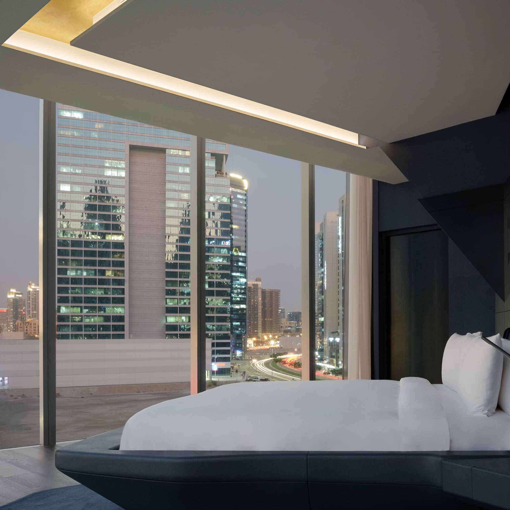 a bed with a view of a city