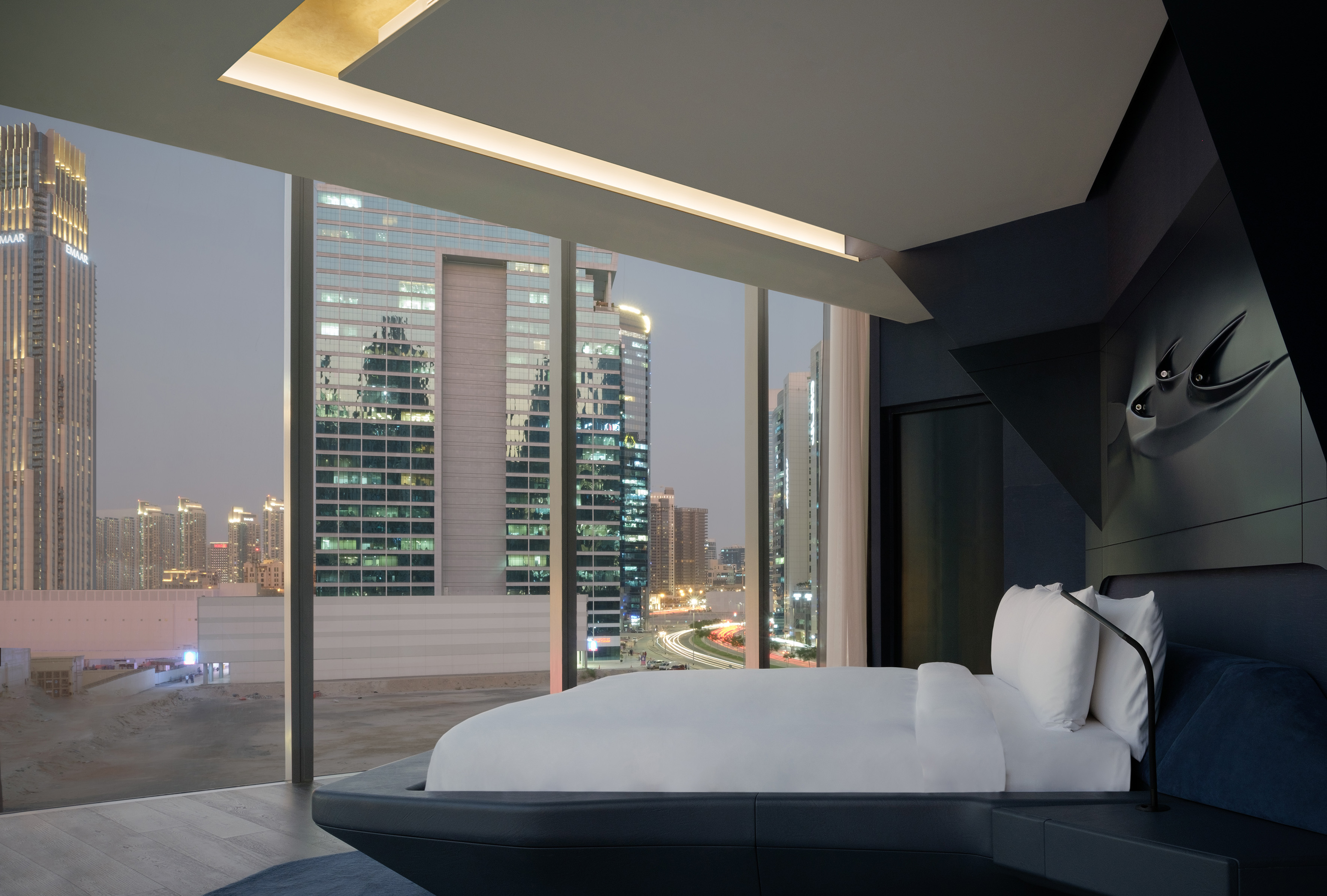 Modern luxury hotel room with panoramic Dubai city skyline view.