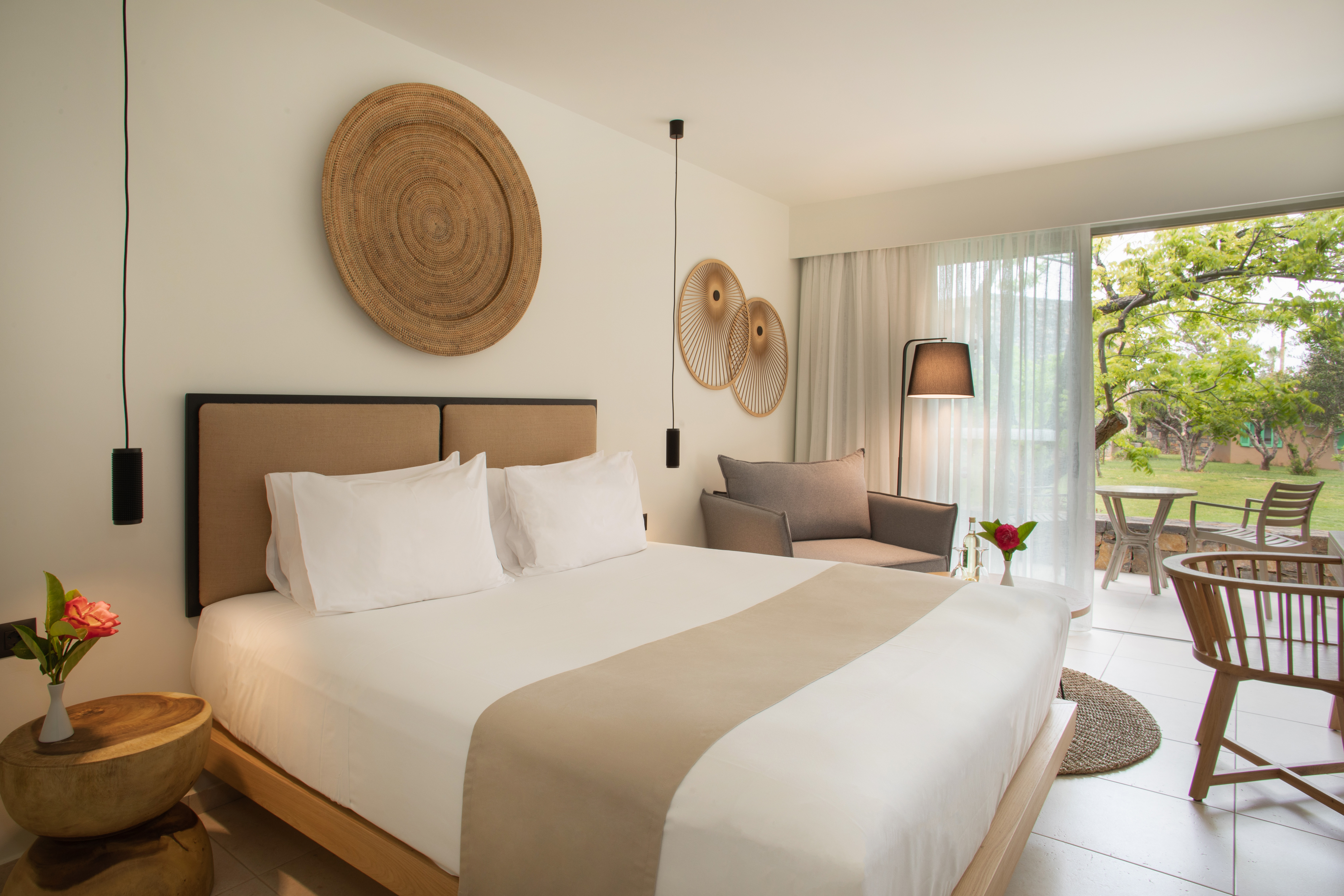 a bedroom with a bed and chairs