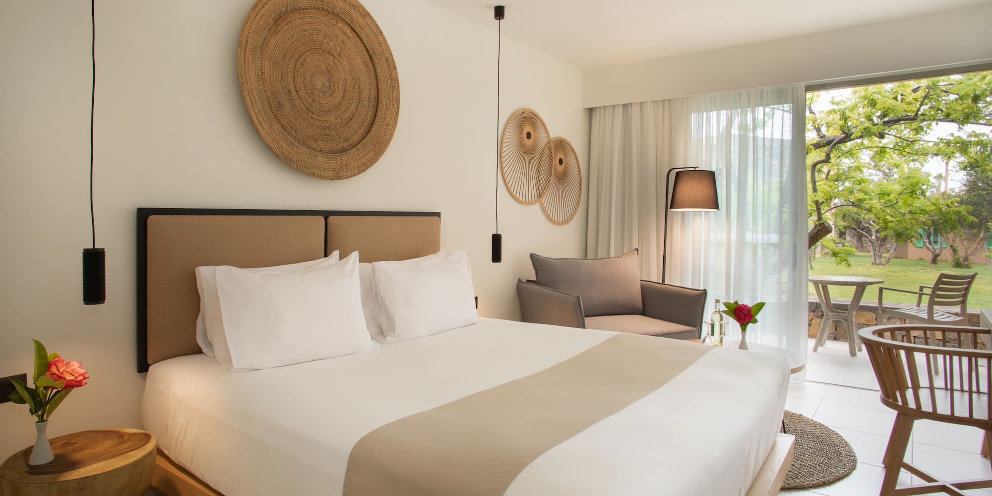 a bedroom with a bed and chairs