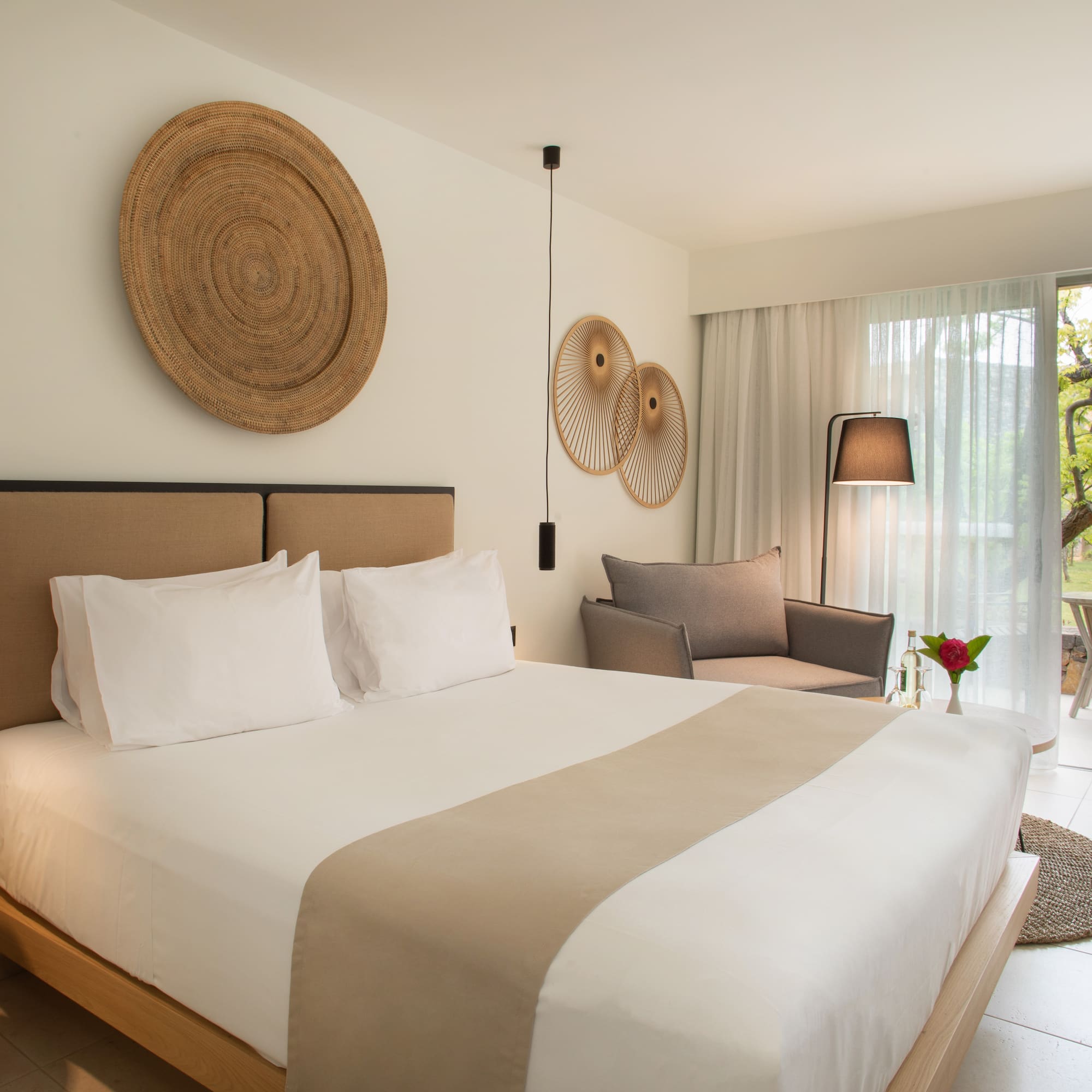 a bedroom with a bed and chairs