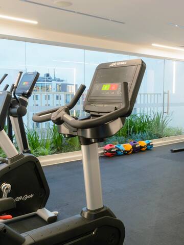 a room with exercise bikes and a large window
