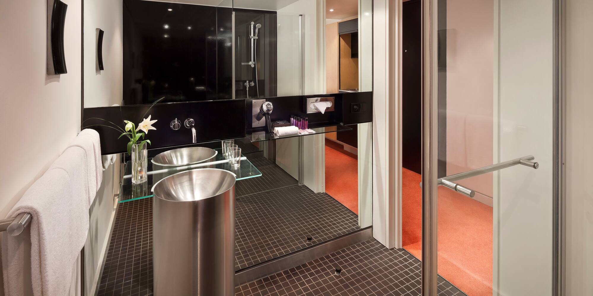 a bathroom with a glass shower door