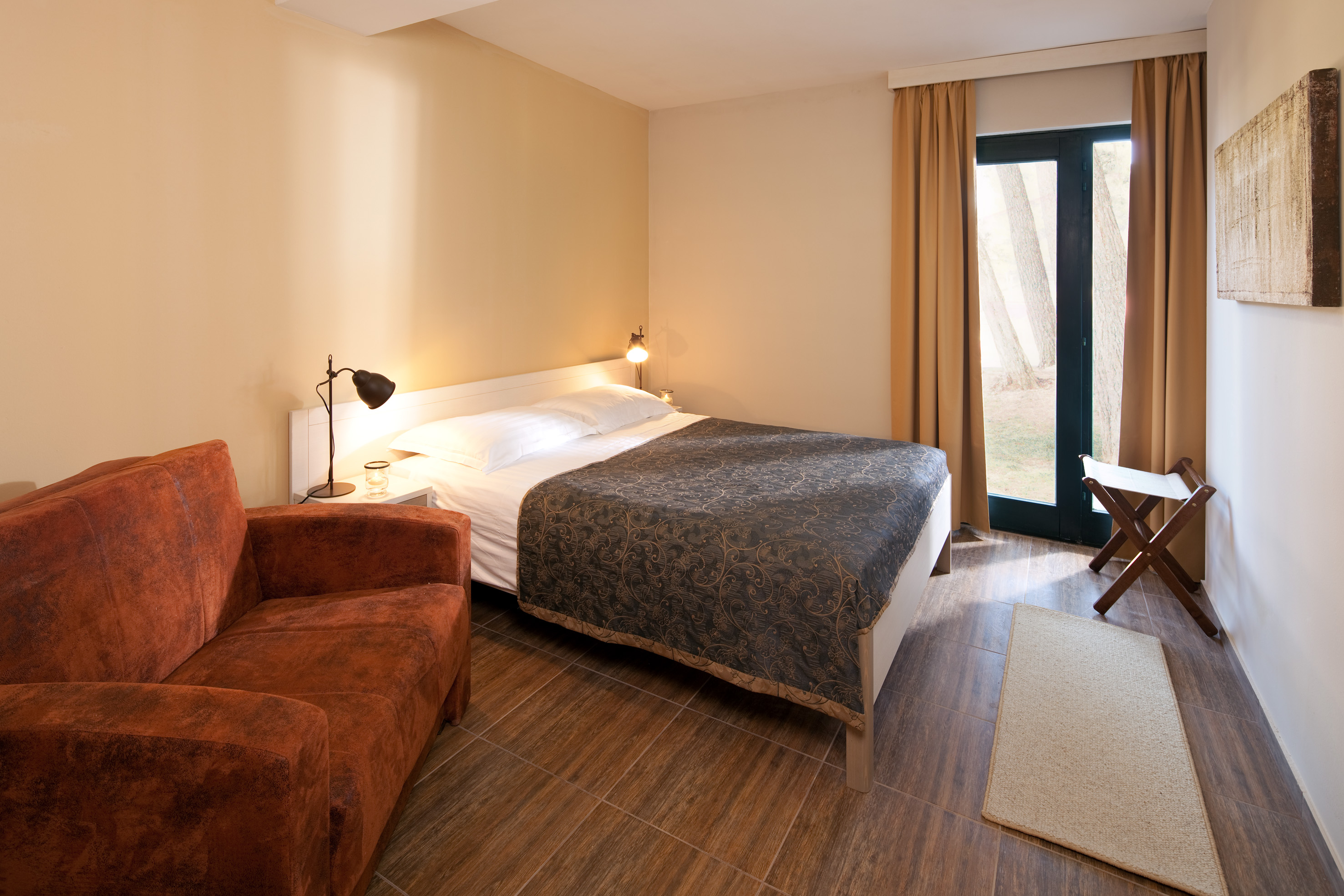 a bedroom with a bed and a chair