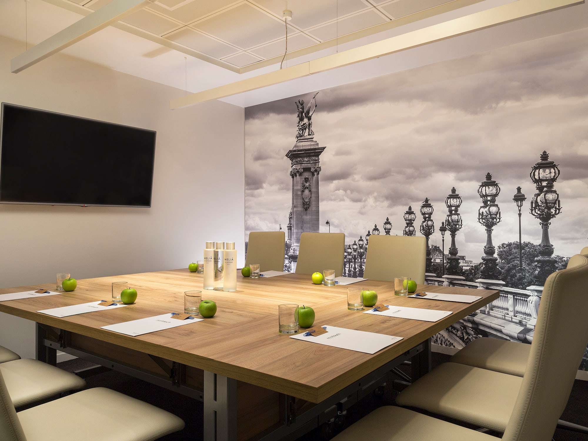 a table with chairs and apples on it