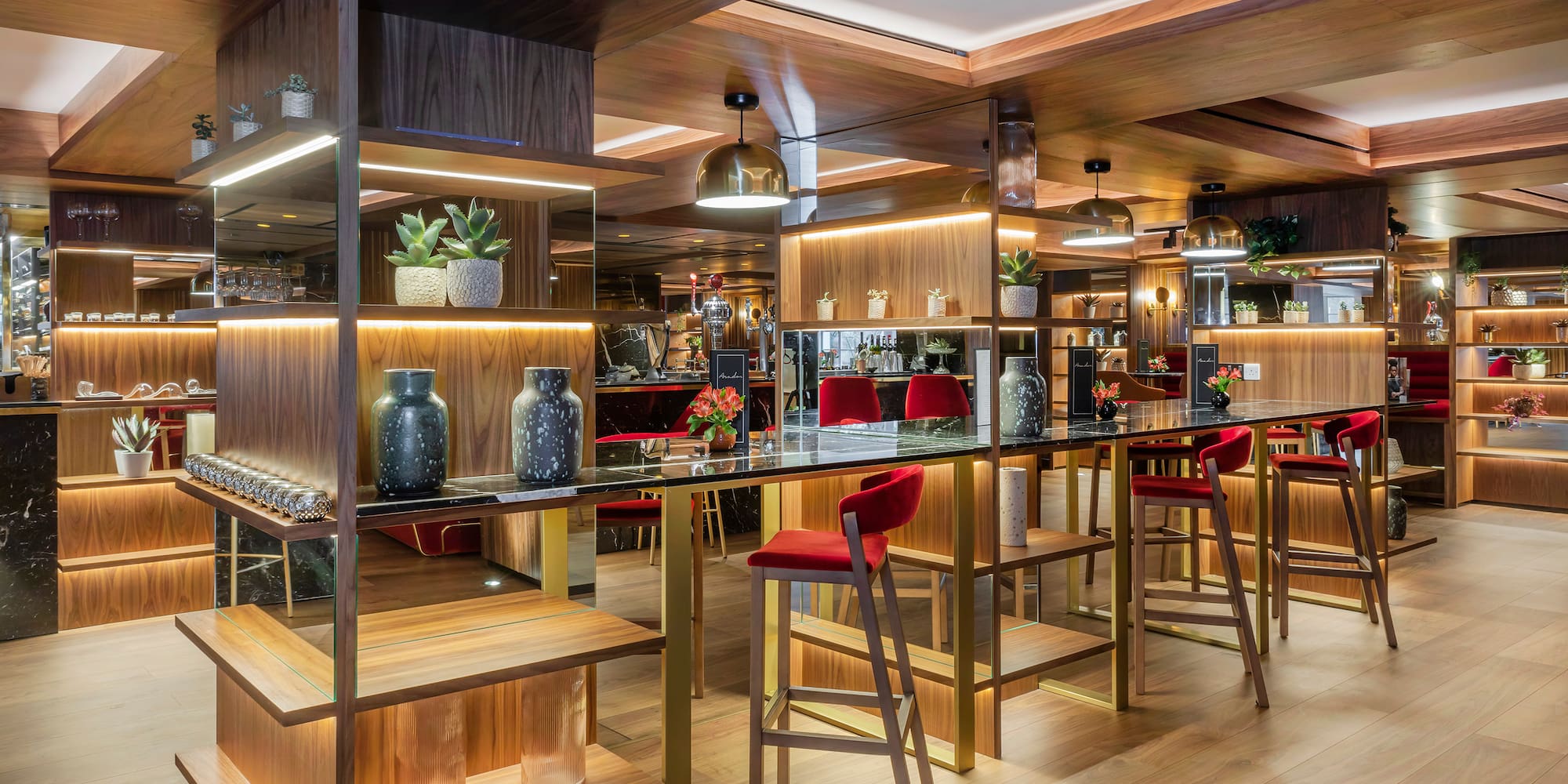 a room with a bar and chairs