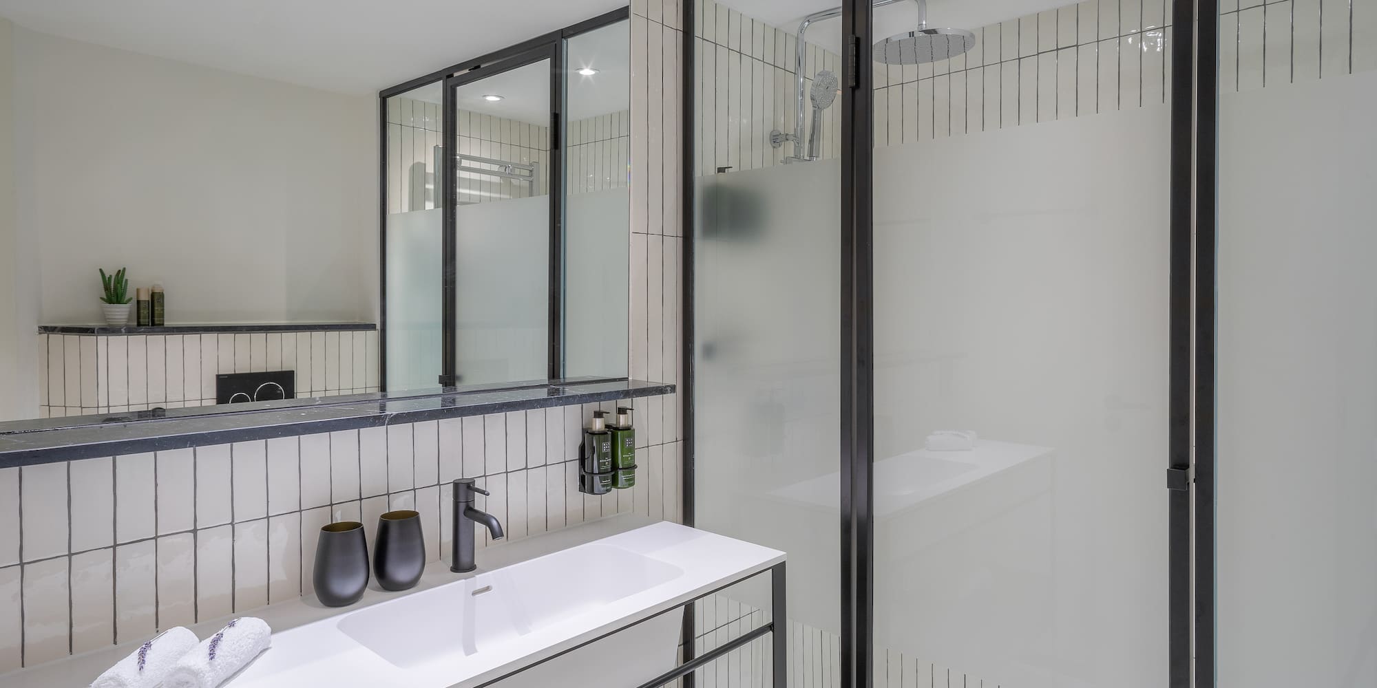 a bathroom with a shower and sink