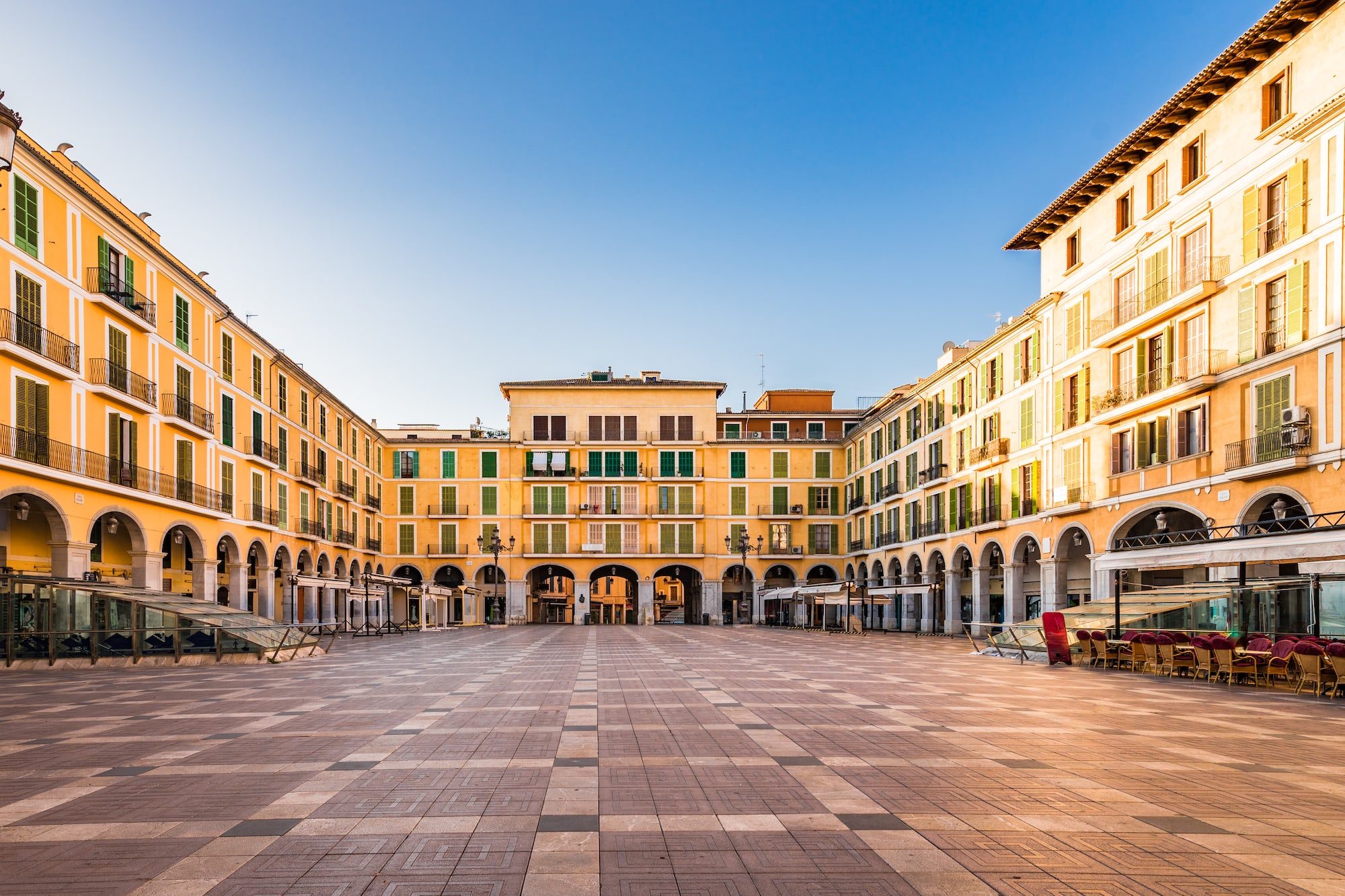 a large square with many buildings and a blue sky