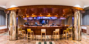 a bar with chairs and a table