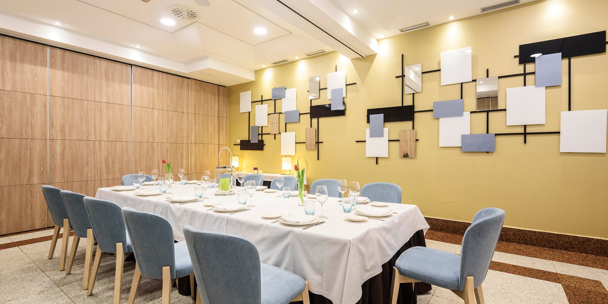 a room with a table set for dinner