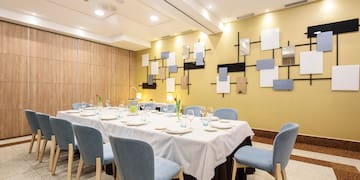 a room with a table set for dinner