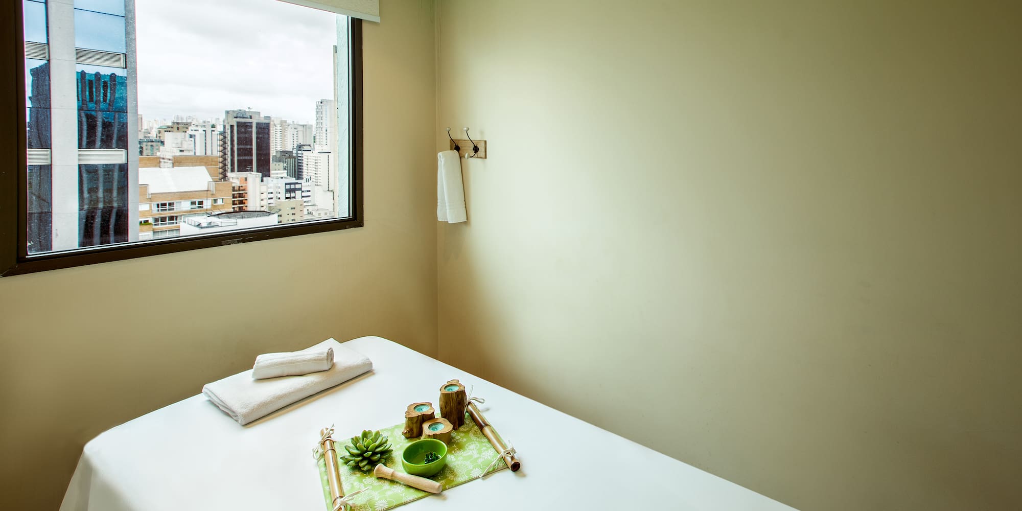 a table with a green tray and towels on it