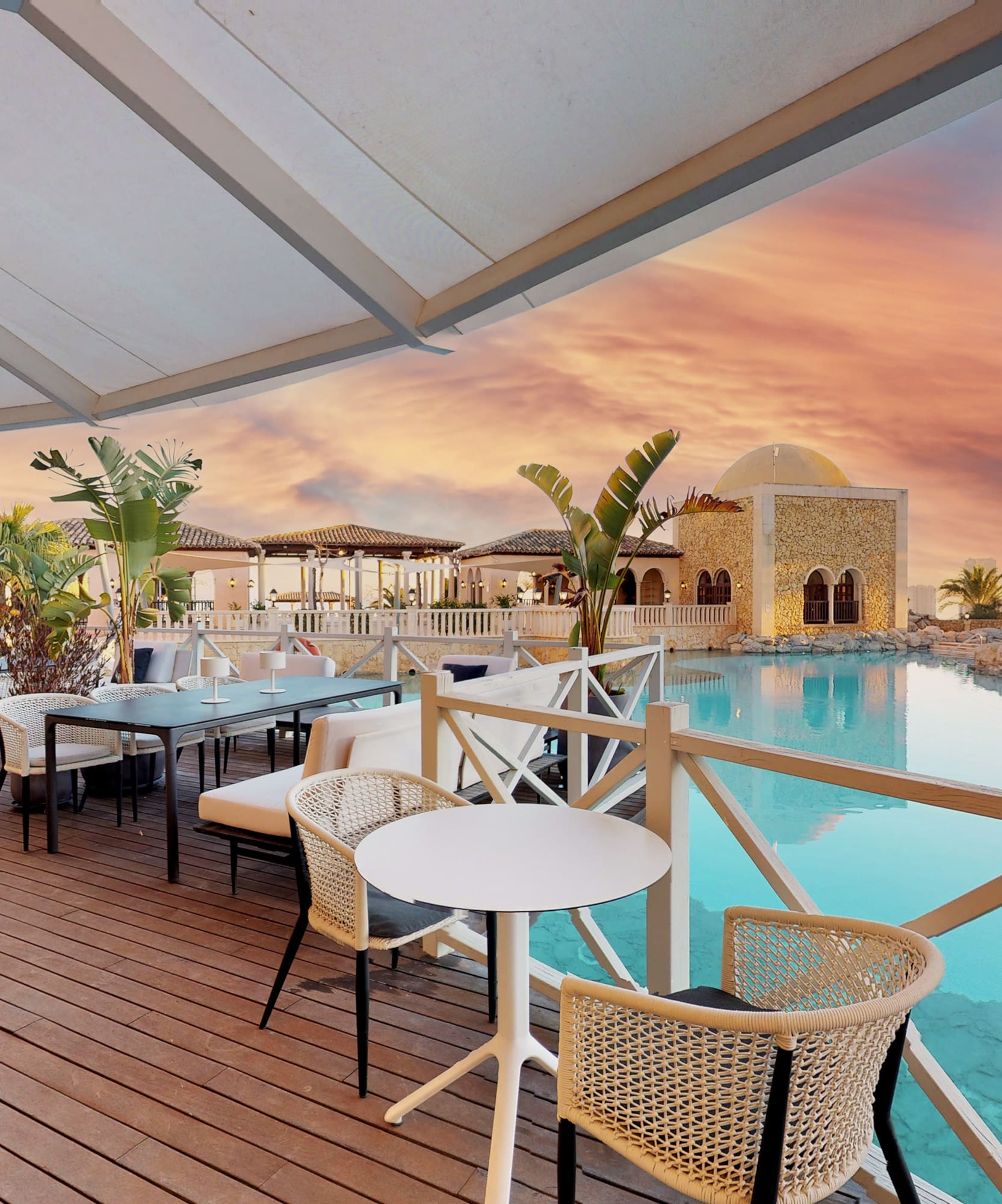 a patio with tables and chairs and a pool