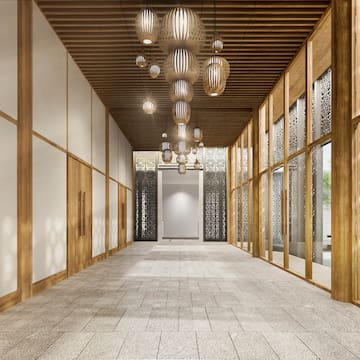 a hallway with a chandelier and glass walls