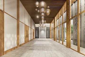 a hallway with a chandelier and glass walls
