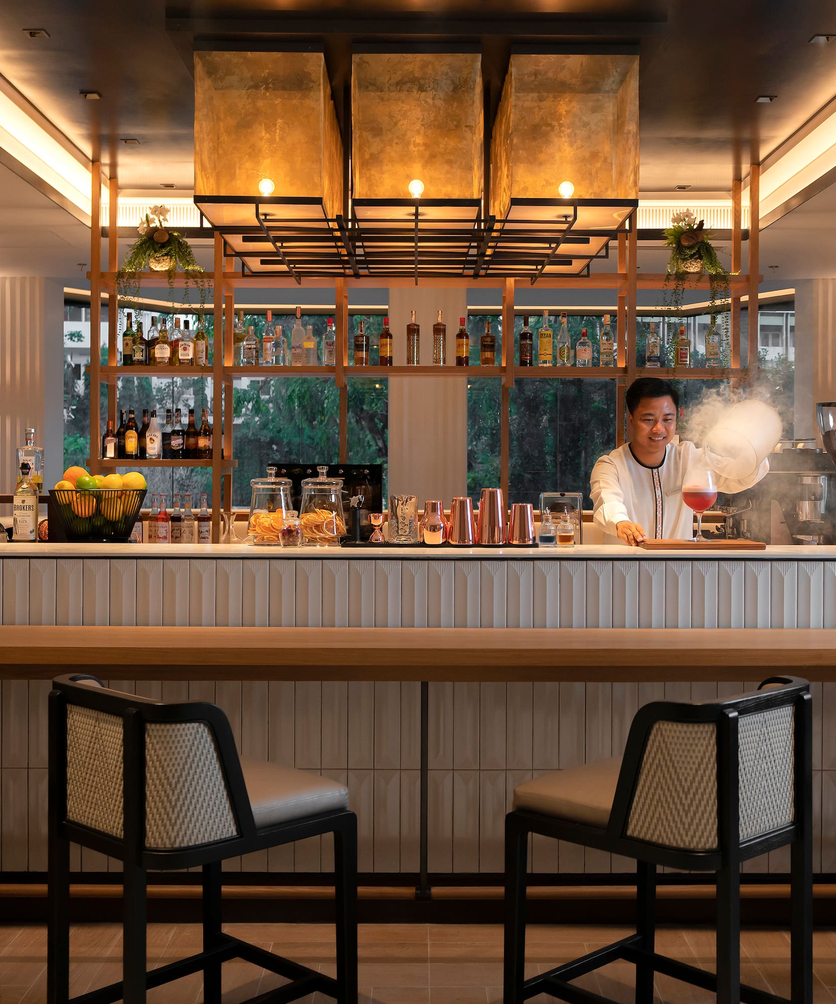 a woman making a drink at a bar