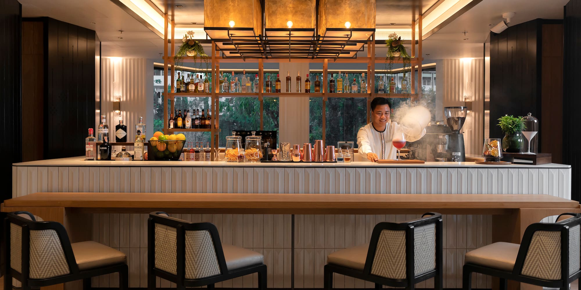 a woman making a drink at a bar