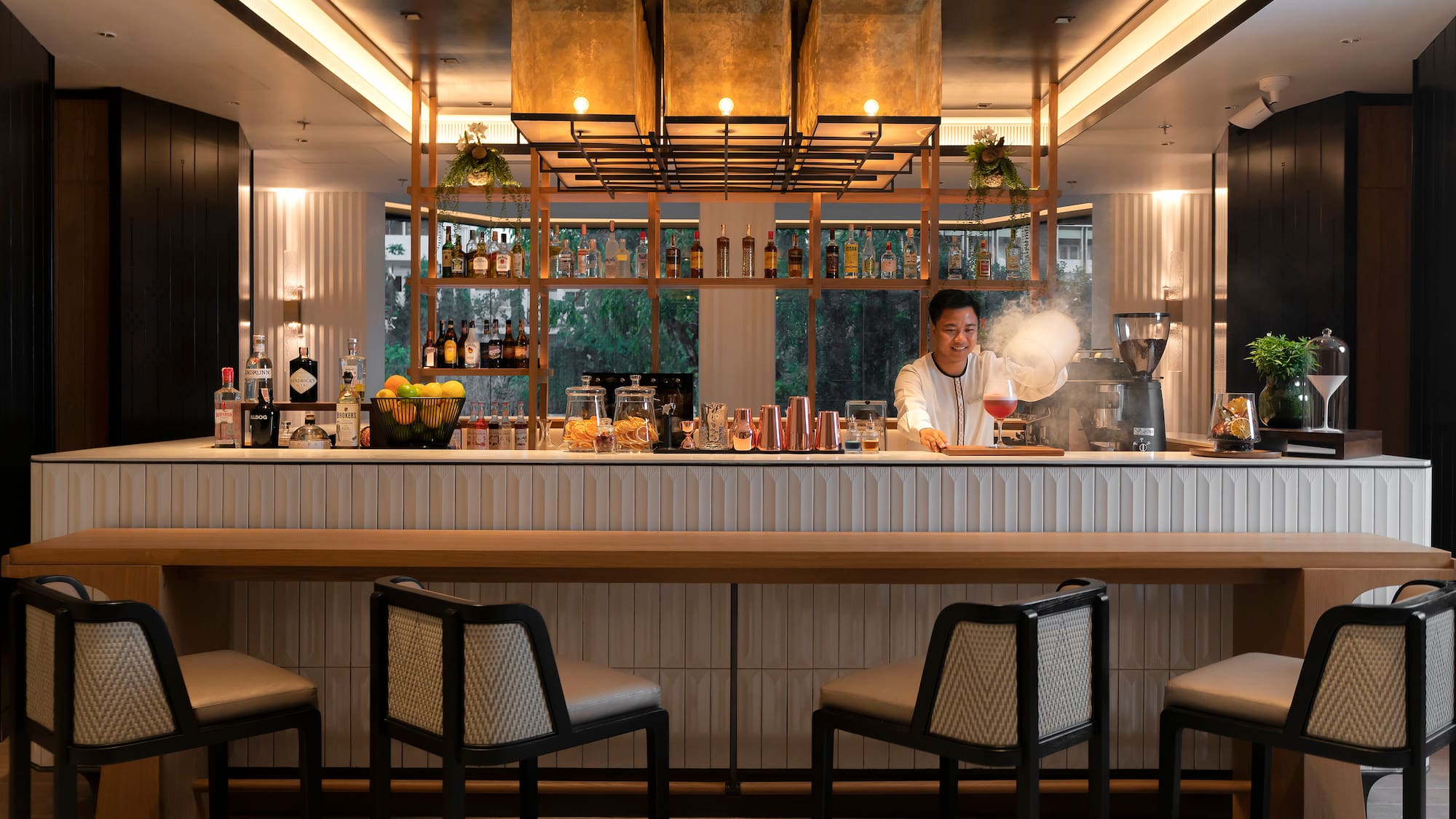 a woman making a drink at a bar
