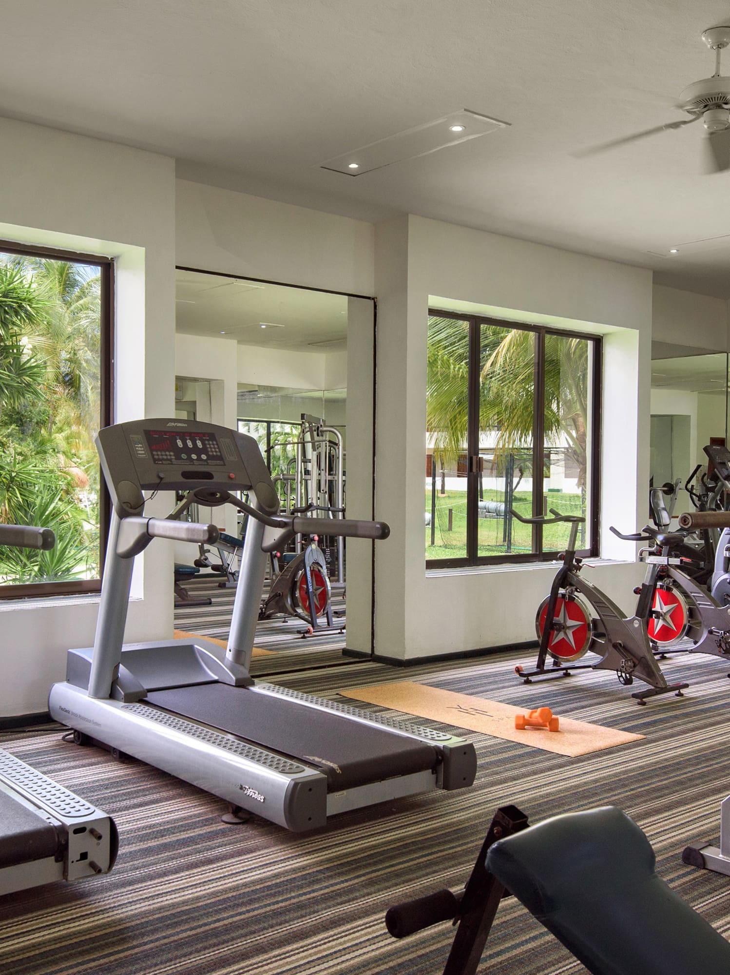 a room with exercise equipment and a clock