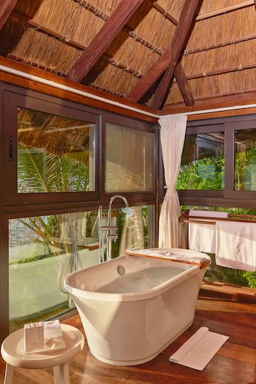 a bathroom with a tub and a shower