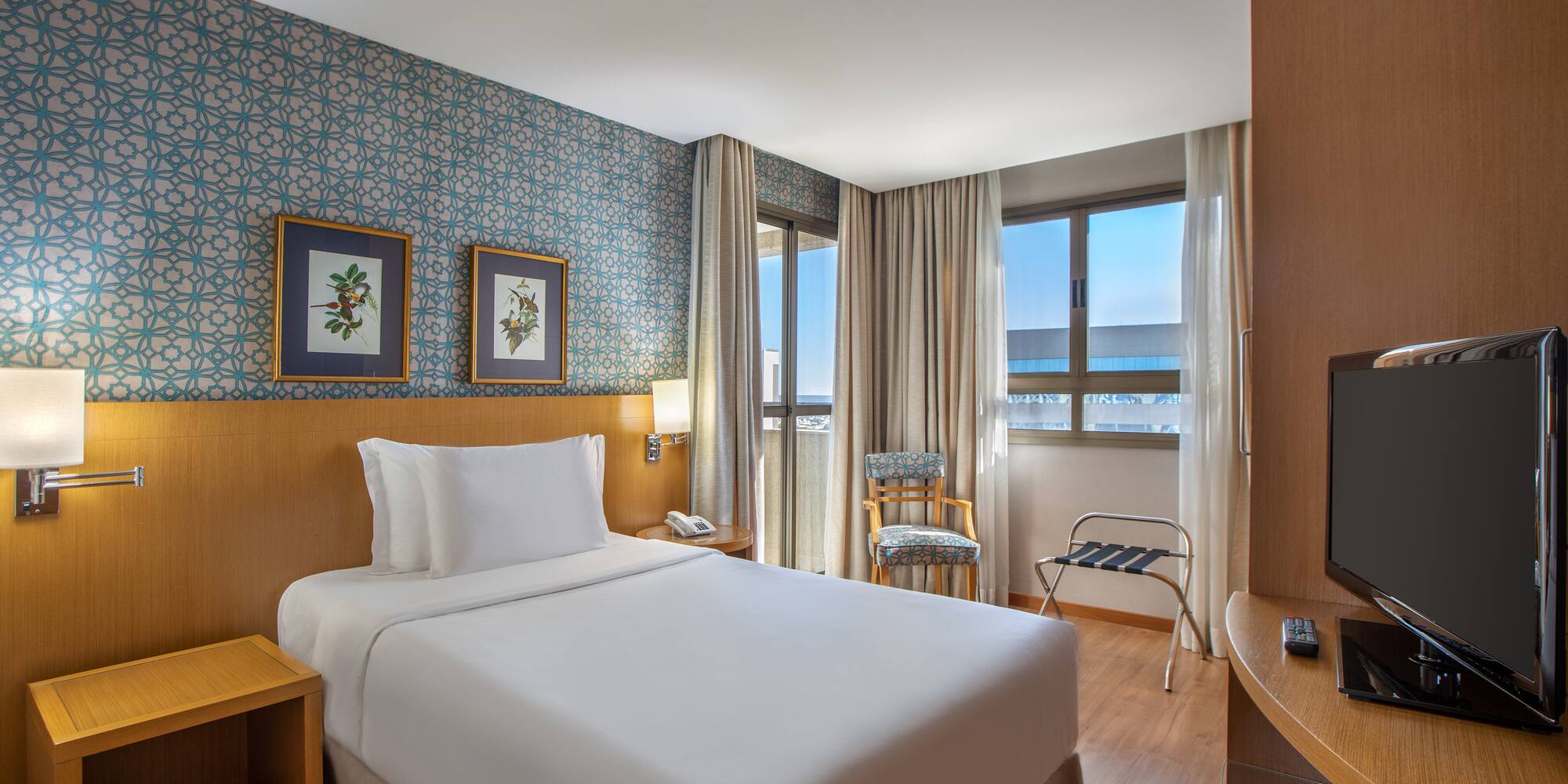 a hotel room with a bed and a table