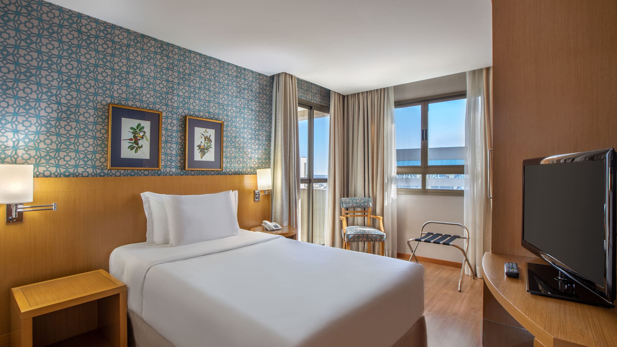 a hotel room with a bed and a table