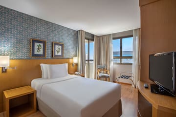 a hotel room with a bed and a table