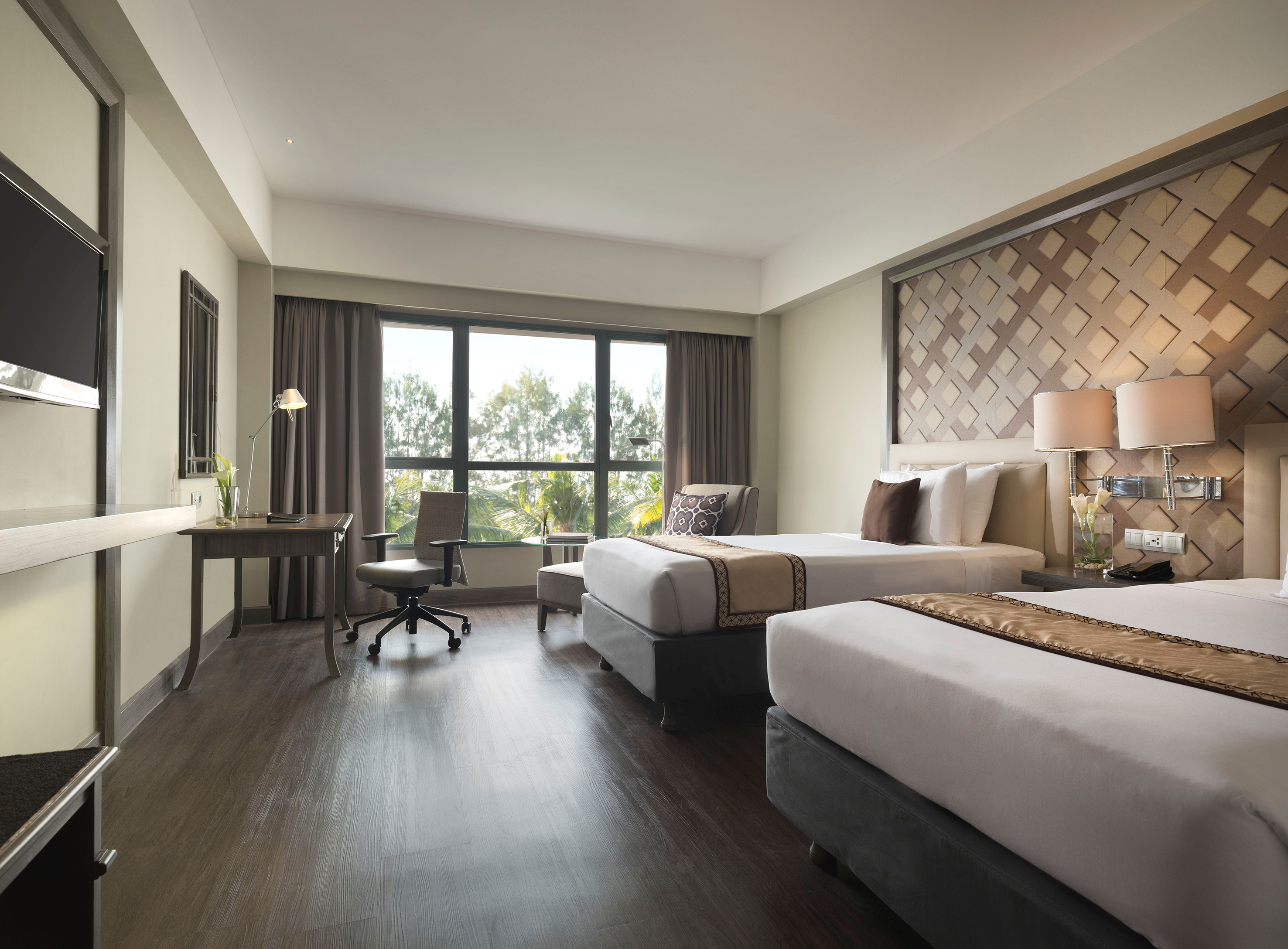 a room with two beds and a desk