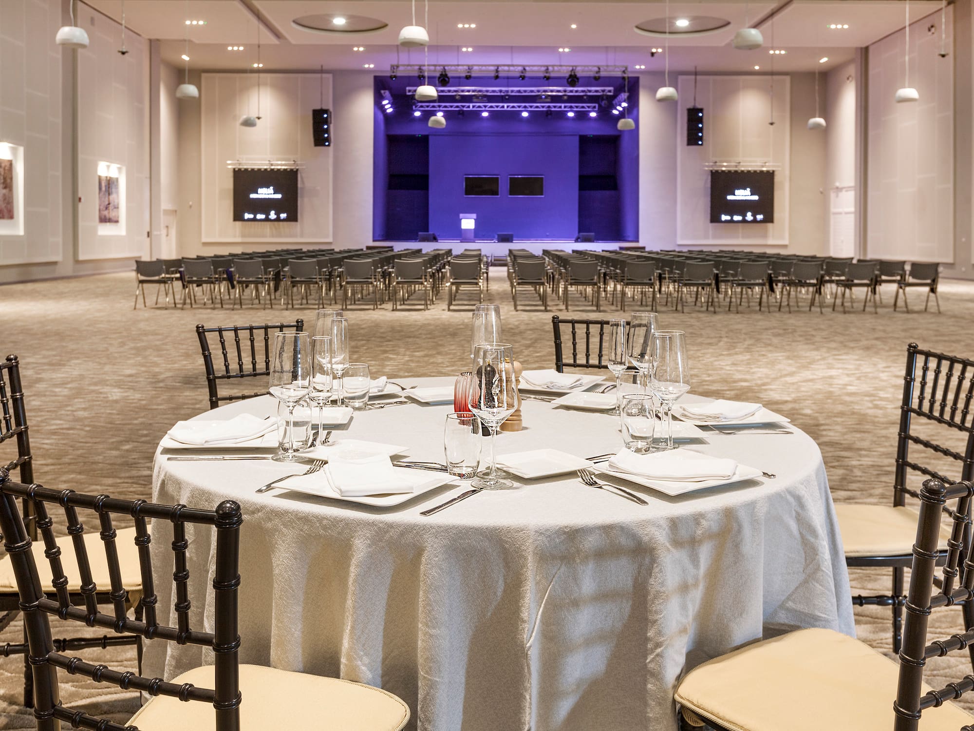 a round table with a white tablecloth and glasses on it