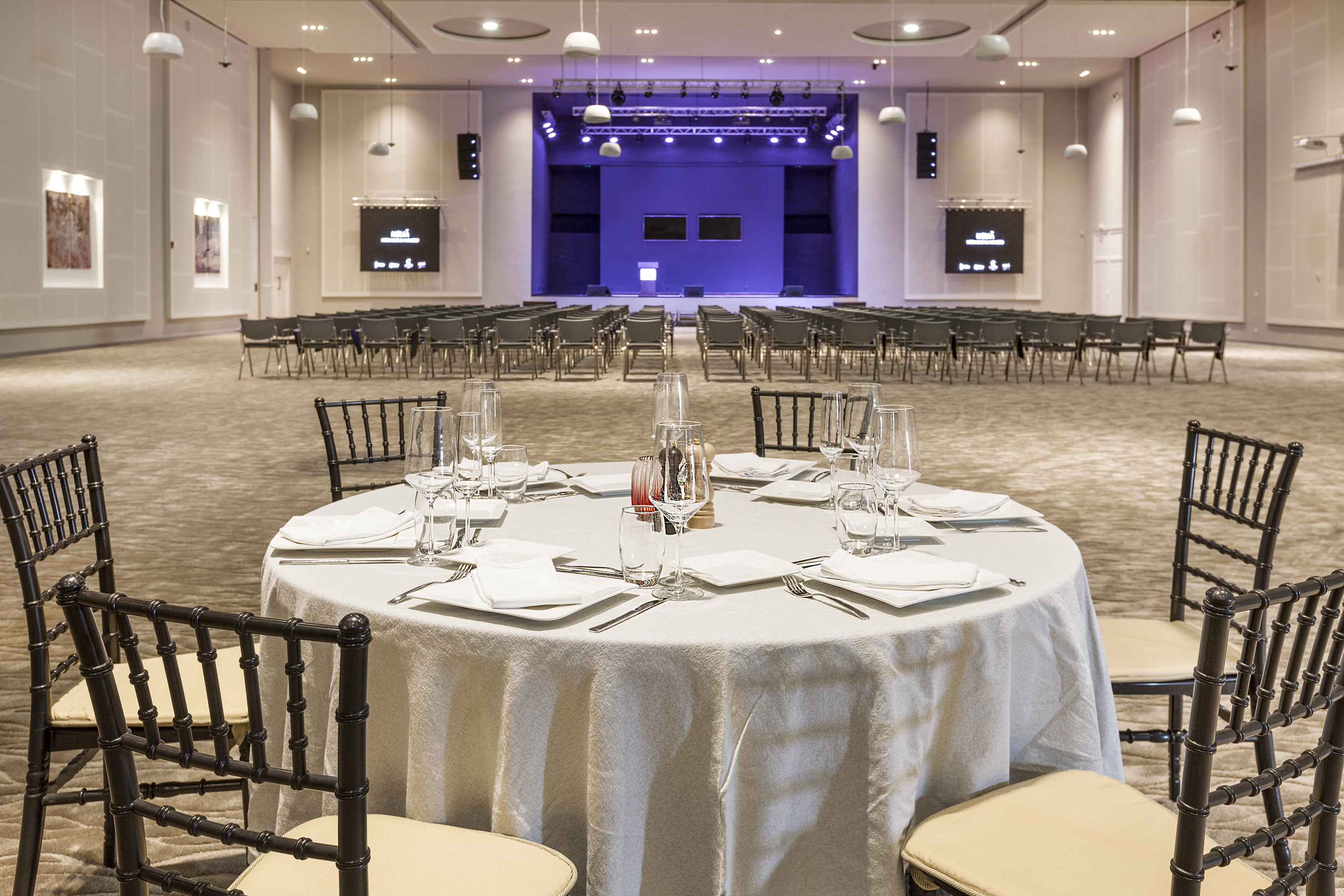 a round table with a white tablecloth and glasses on it