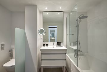 a bathroom with a mirror and a bathtub