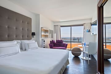 a room with a large bed and a television