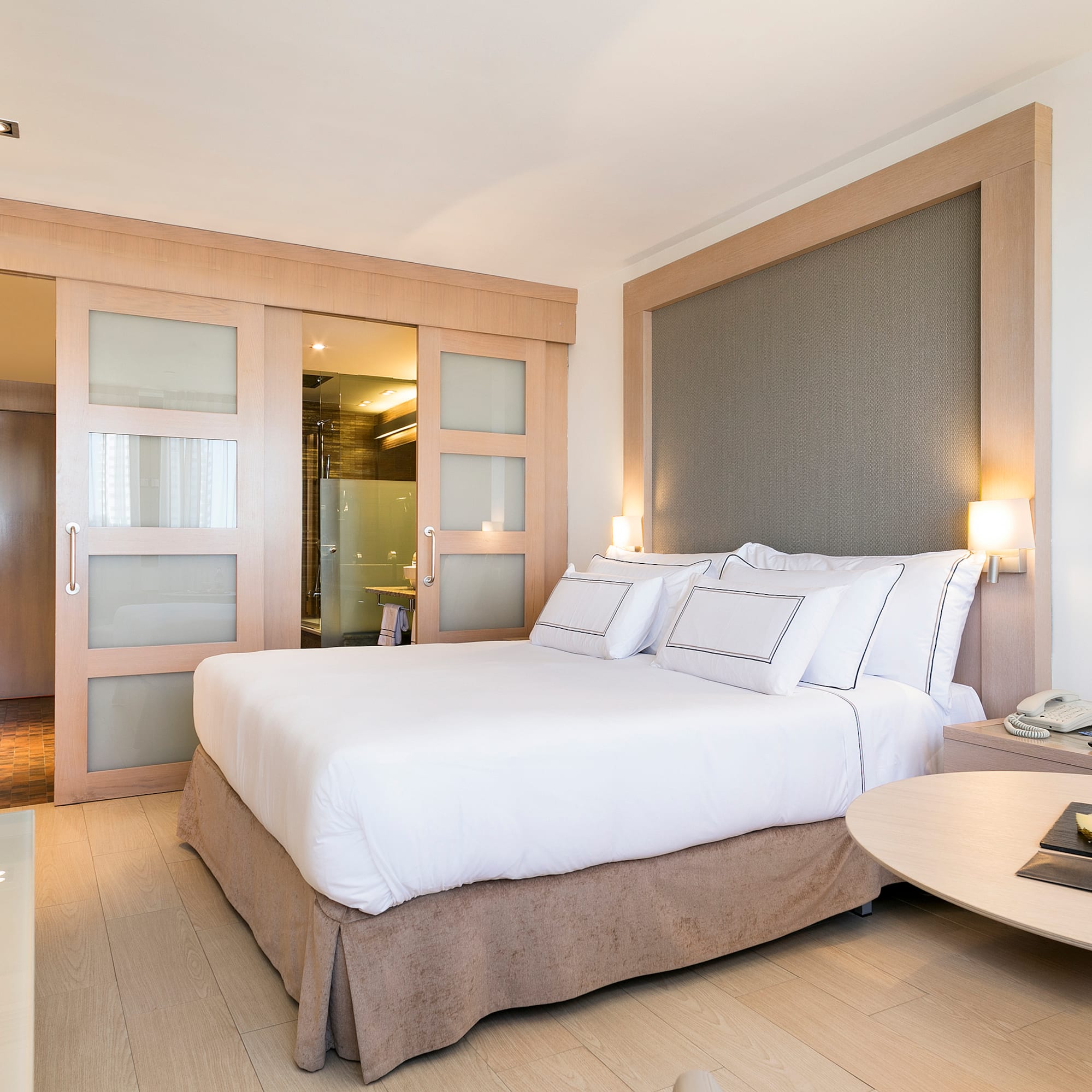 a bedroom with a bed and a table