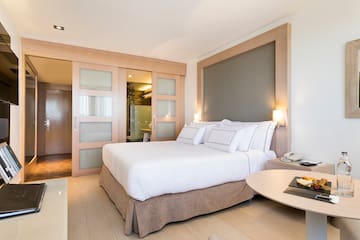 a bedroom with a bed and a table
